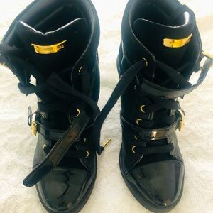 Women’s Michael Kors black wedge high tops.